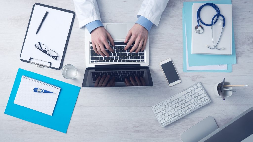 a photo of a medical professional on a laptop