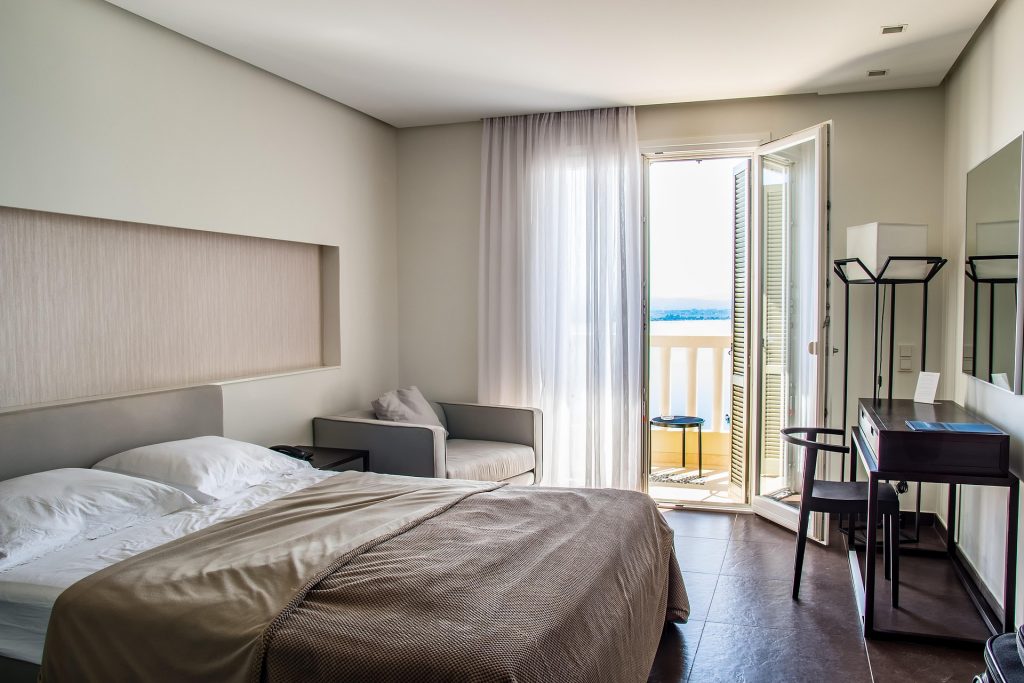 a hotel room with a view over the sea
